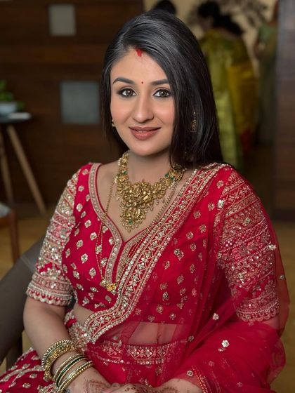 Another beautiful shot of the bride's reception look. The soft lighting catches her glow, showcasing the seamless blend of her makeup.