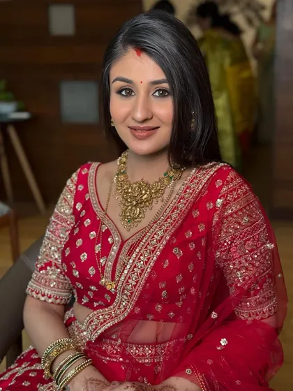 Another beautiful shot of the bride's reception look. The soft lighting catches her glow, showcasing the seamless blend of her makeup.