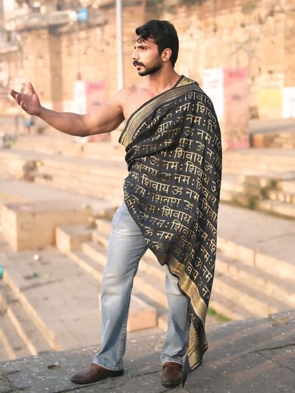 A profile shot capturing a moment of strength and contemplation, with the hand gesture adding a layer of traditional meaning.