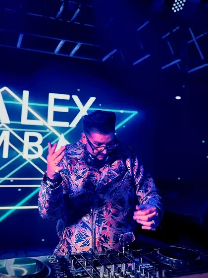 Lost in the music under the cool blue lights. This photo captures a moment of pure focus and connection with the beat.