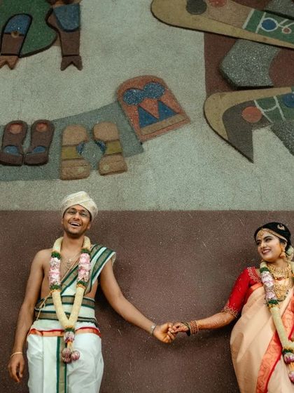A duplicate of 85, a wide shot of the couple against an artistic wall.