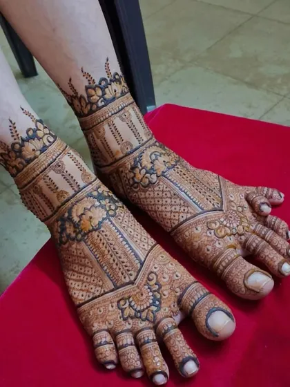 A stunning and intricate design for a bride's feet. The pattern flows from the ankle down to the toes, with a mix of floral elements and geometric grids for a rich look.