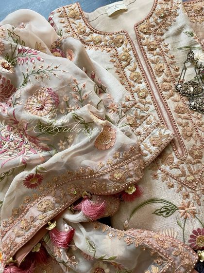 A close-up of the dupatta and sleeve, highlighting the tassels and the sequin work.