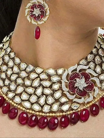 A stunning uncut Polki necklace with a floral ruby motif. This is a high-end designer piece for a bride with discerning taste.