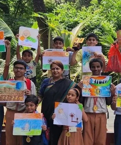 The winners of the art competition proudly display their artworks based on themes related to Gandhiji and India. Their talent was truly impressive.