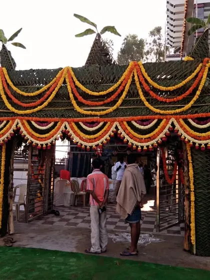 For a truly authentic housewarming, I design and build traditional *chappra* entrances. This grand entrance is woven entirely from fresh coconut leaves and decorated with beautiful garlands of marigold flowers, creating a spectacular and auspicious welcome for your guests.