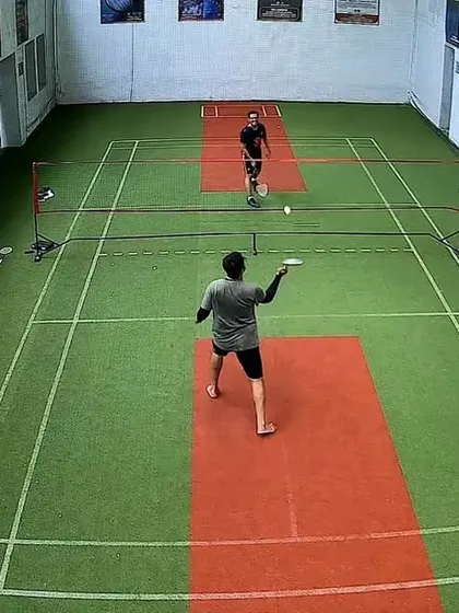 A high-angle view of a singles rally. You can see the strategy as the players move around the court.