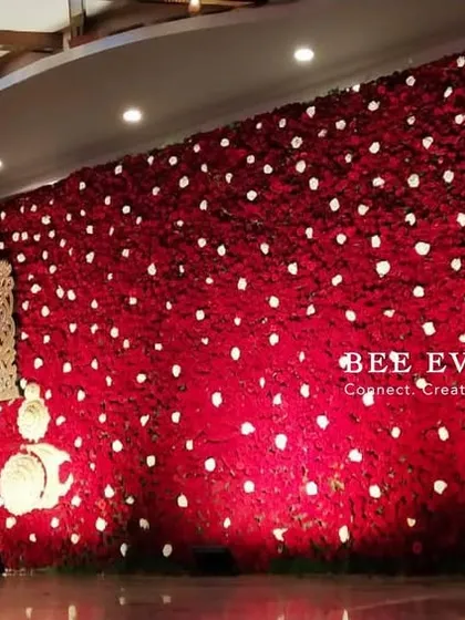 A truly grand statement wall for a reception. We created this entire backdrop using thousands of red roses, with a divine motif of Lord Balaji, blending spiritual reverence with breathtaking floral artistry.