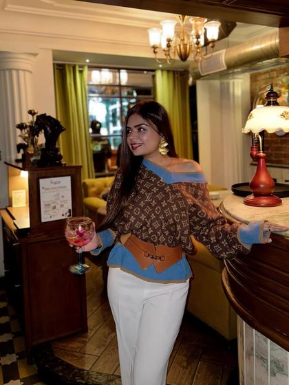 The same stylish outfit, captured in a different part of the restaurant.