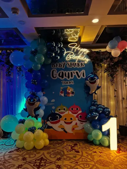 A wider view of the Baby Shark setup, showing the "Happy Birthday" neon sign.