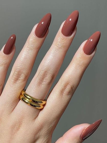 A warm, terracotta brown on long almond nails. This earthy shade is so on-trend and stylish.