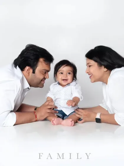 A bright and joyful family portrait session in our studio. We love capturing these happy, interactive moments with parents and their little one against a clean, classic white background.