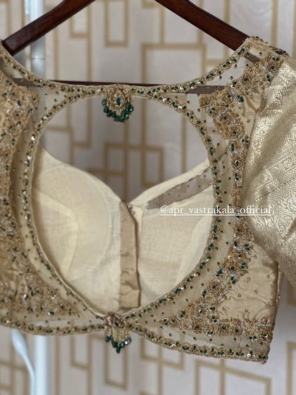 The full back view of the gold blouse.