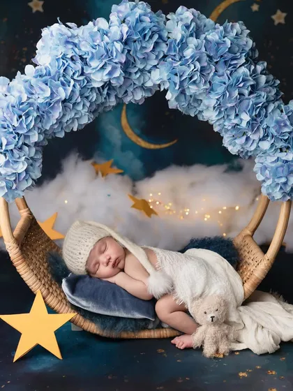 Gently swaying into dreams with a teddy bear friend. This magical night sky setup is perfect for creating a whimsical and peaceful portrait of your sleeping baby.