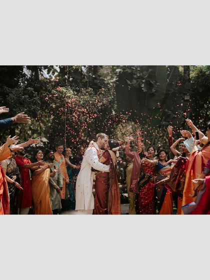 A moment of pure celebration as guests shower the newly married couple with flower petals. This image perfectly captures the joy and energy of a wedding at our venue.