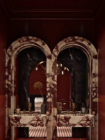 I believe washrooms should surprise and delight guests. In the Koko Hyderabad ladies' room, we used bold crimson walls and custom-arched vanities made from a dramatic red and white marble to create a memorable, high-impact space that feels like a destination in itself.