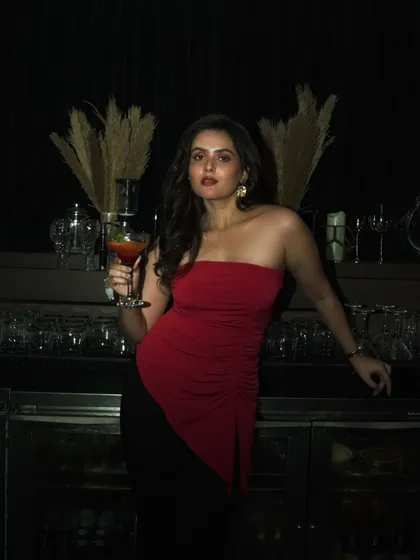 This shot captures the full evening look, with soft glam makeup that is perfect for a night out. The focus is on radiant skin and defined eyes that don't feel heavy.