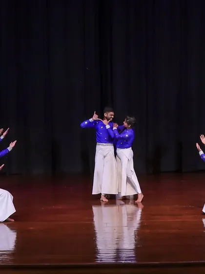Our choreography includes a mix of large group formations, smaller ensemble pieces, and duets to create a varied and engaging performance. This moment captures a central interaction between two lead characters, surrounded by the full dance troupe.