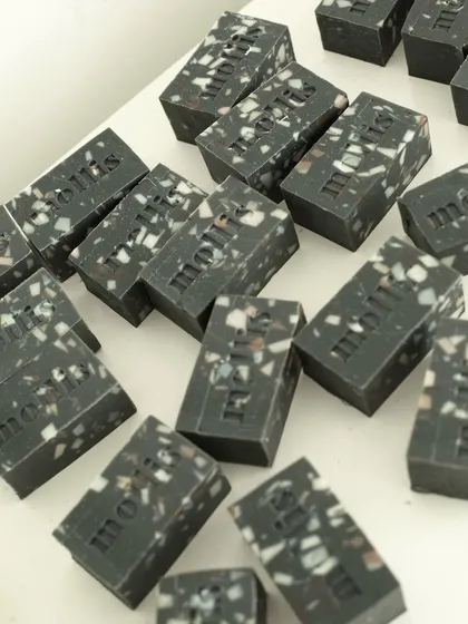 A peek into my daily soap cutting table, featuring a batch of terrazzo-style charcoal soaps.