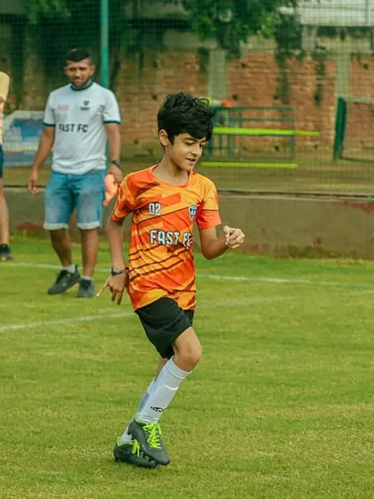 A young player from our U8 team dribbling the ball up the field during the Pride Cup.
