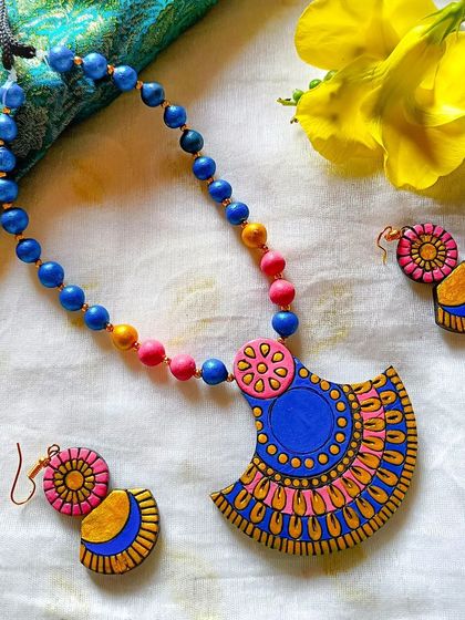 A bright and bold blue and pink version of the fan-shaped pendant necklace.