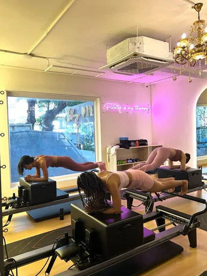 Planking together makes the burn better. This synchronized plank on the reformer box is a true test of core endurance and teamwork.