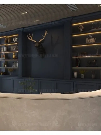 This lobby in Mansarovar Garden features a bold, navy blue library wall with integrated shelving and a statement deer head sculpture, creating a sophisticated, den-like atmosphere.