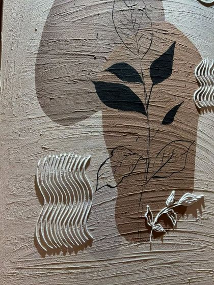 A detail shot of the botanical-themed arched panel, showing the delicate sculpted leaves and wavy patterns that add a tactile dimension to the artwork.