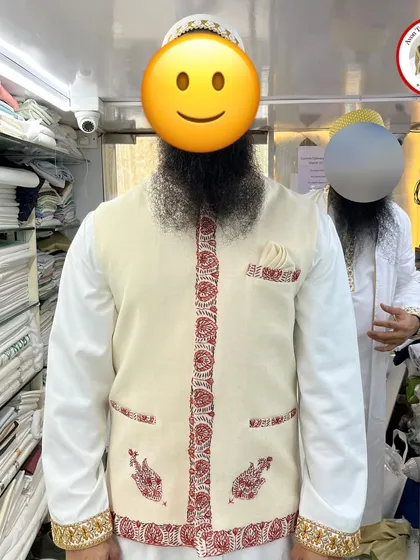 A beautiful example of a single shawl transformed into a custom-fit Koti. We carefully placed the original red and gold embroidery along the borders, cuffs, and pockets to create a truly unique and personal garment for a happy client.