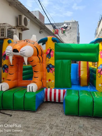 This jungle-themed bouncy features a large inflatable tiger entrance. It's a fun and adventurous design that captures the attention of kids.