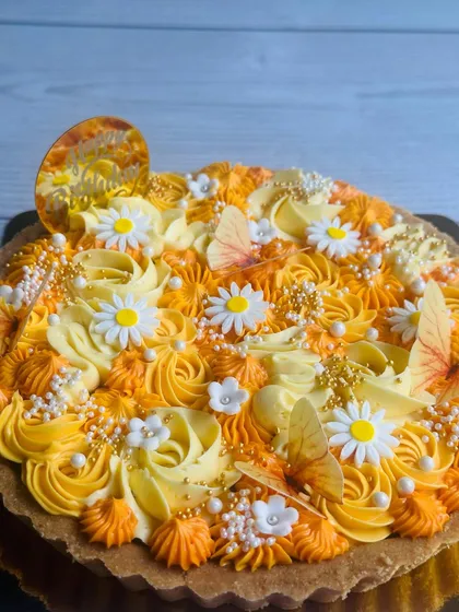 Another angle highlighting the vibrant yellow and orange hues and the shimmering pearl sprinkles that add a touch of magic to this beautiful tart.