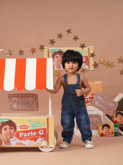 The little 'Parle-G girl' stands proudly by her biscuit cart in this adorable, nostalgic themed portrait.