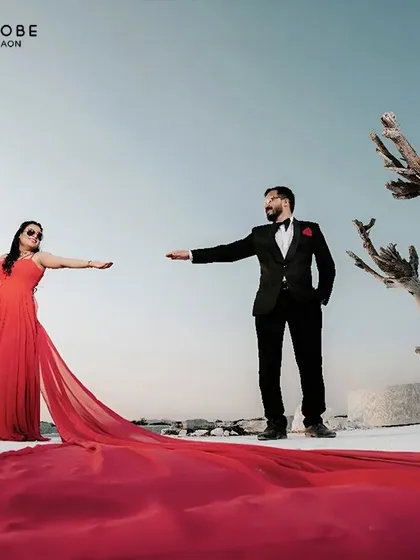Your pre-wedding shoot deserves a showstopper. This fiery red trail gown creates a stunning contrast against a stark landscape, making for an unforgettable photo.