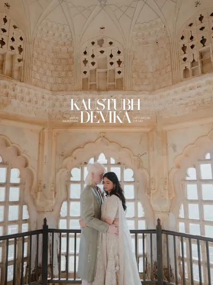 An intimate embrace within the intricate latticework of a Jaipur palace. The soft light filters through the jharokha, creating a serene and romantic portrait that feels both timeless and personal.