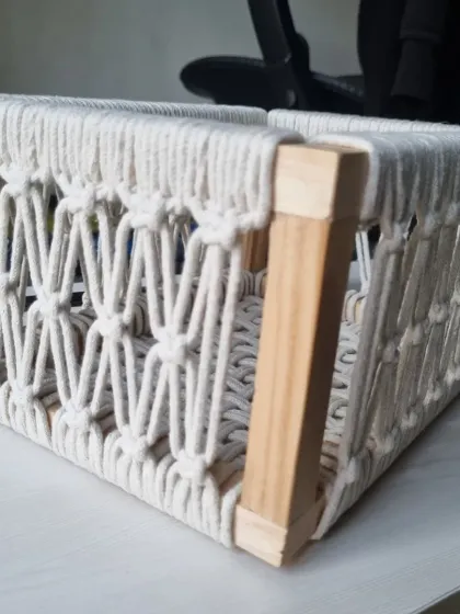 The corner detail of the basket, where the wooden frame is securely wrapped with cord for a seamless and durable finish.