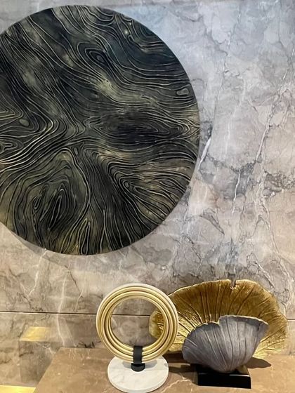 "Cosmic Currents" installed in its new home. This circular piece, with its wood-grain-like texture, adds warmth, soul, and a sense of grounding to the space.