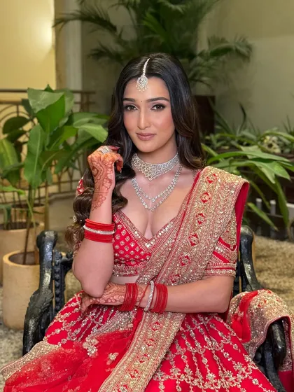 Another beautiful shot of the bride, showcasing her radiant smile and the flawless finish of her makeup. This look is perfect for the bride who loves tradition with a modern twist.