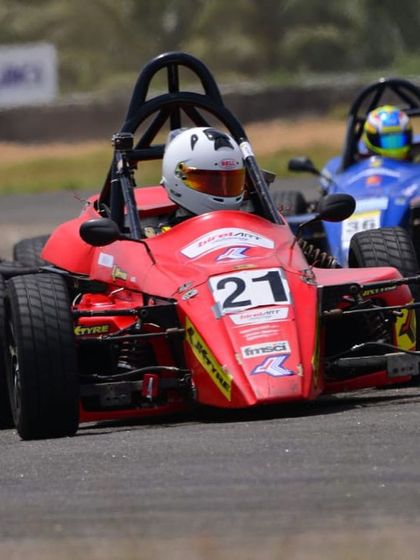 Our driver in the red number 21 car, battling for position against a competitor during a JK Tyre Formula LGB Championship race.