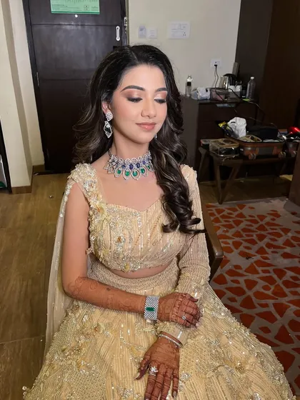 A close-up of Hershee's Sangeet look. The soft curls and glamorous makeup create a romantic and elegant vibe, perfect for the occasion.