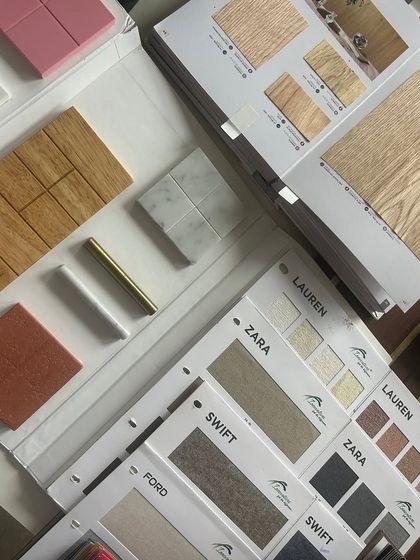 A collection of material samples and catalogues on our desk. The process of selection involves reviewing hundreds of options to find the perfect combination of color, finish, and durability.