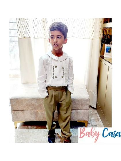 A formal look for a young gentleman. This outfit with a pintuck shirt and tailored trousers is perfect for family weddings or formal events, offering a sophisticated yet comfortable style.