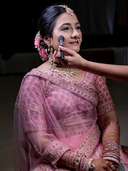 A behind-the-scenes moment of creating this simple and beautiful look. A light touch of blush on the cheeks adds a fresh, healthy pop of color.