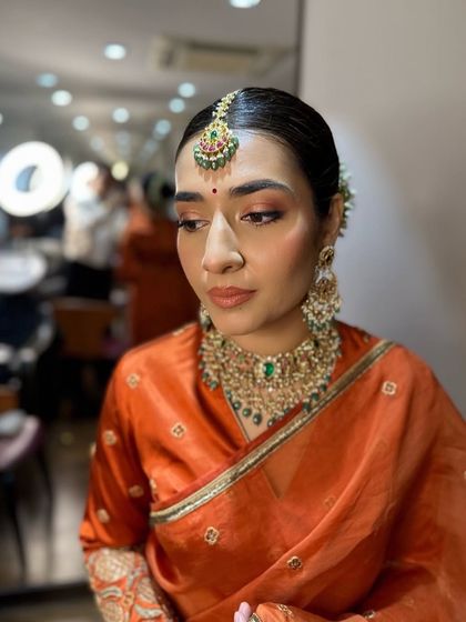 A slightly different angle of Hanita's look, with the studio lights in the background. Her makeup remains soft and luminous, showcasing a modern take on traditional beauty.