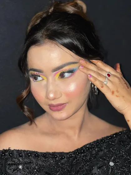 A detailed shot of the graphic liner and color placement in this artistic makeup style.
