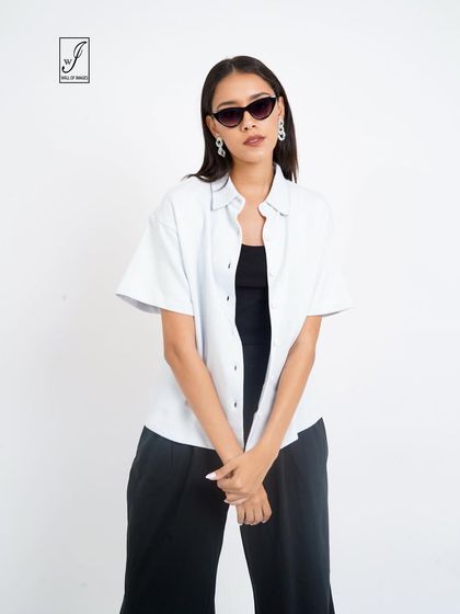 A confident pose with sunglasses, adding a touch of attitude to the lookbook image.