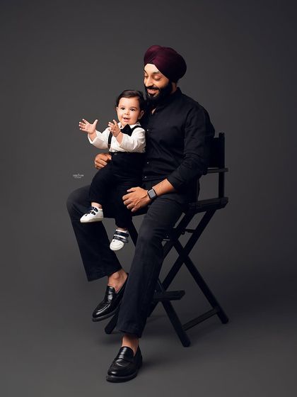 The bond between a father and his son is truly special. This candid shot captures a happy, playful moment during their family session.