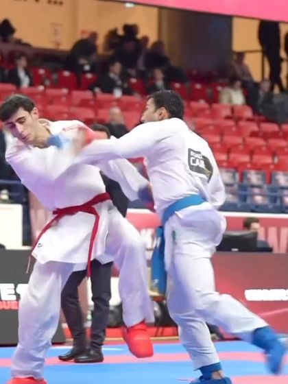 A close-range punching exchange, demonstrating the importance of timing and defensive blocking in kumite.