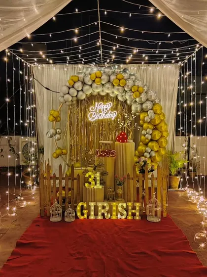 Don't have a large venue? No problem. We can transform any space, like this terrace, into a beautiful party spot with a canopy of fairy lights, a stylish balloon arch, and a personalized backdrop for a memorable birthday surprise.