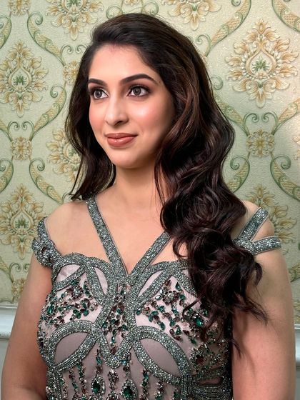 This shot showcases the beautiful contouring and highlighting that gives her face a sculpted, radiant glow.