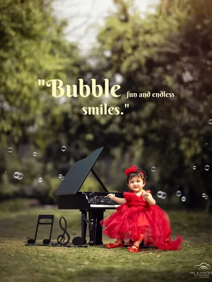 Bubble fun and endless smiles. A joyful little girl in a red dress plays at her mini piano, surrounded by bubbles in this magical outdoor photo.